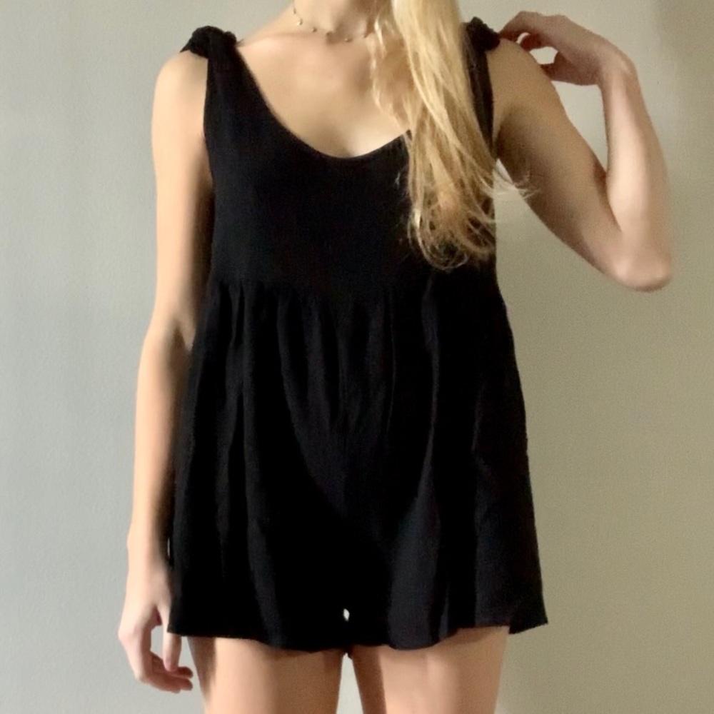 Black romper with tie straps. Never been worn, great condition.